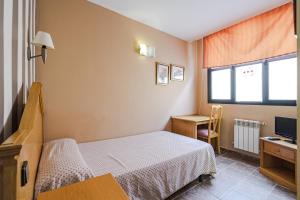 Postel nebo postele na pokoji v ubytování Hostal Don Juan