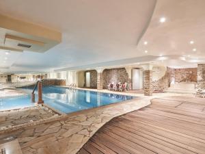 a large swimming pool in a hotel room with at Hotel Dolomiti in Brentonico