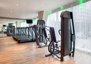 a gym with a row of treadmills and ellipticals at Park Plaza Leeds in Leeds