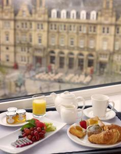 a table with two plates of breakfast food and a window at Park Plaza Leeds in Leeds