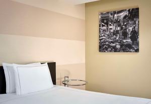 a bedroom with a bed with a picture on the wall at Park Plaza Leeds in Leeds