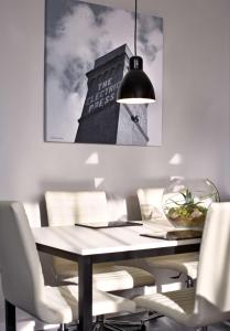 a dining room table with chairs and a picture of a building at Park Plaza Leeds in Leeds