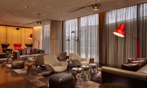 a lobby with a waiting room with couches and chairs at Park Plaza London, Park Royal in London