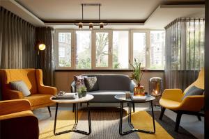 a living room with a couch and two chairs at Park Plaza Vondelpark Amsterdam in Amsterdam