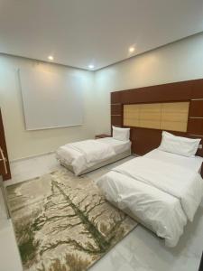 En eller flere senge i et værelse på أباهي للوحدات السكنية الحوطة