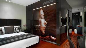 a bedroom with a wall with a face painted on it at Park Plaza London Westminster Bridge in London