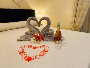 a bed with two towels and a couple of hearts at The Maltese Sun in Sliema