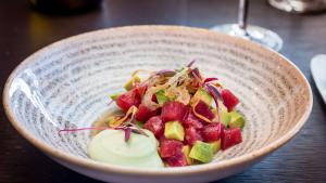 a bowl of food on a wooden table at Park Plaza London Westminster Bridge in London
