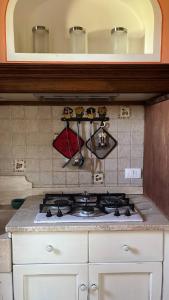 a kitchen with a stove top in a kitchen at English Garden Cortona in Cortona