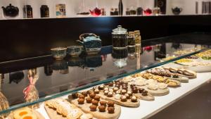 a display case with a bunch of cookies and other desserts at Park Plaza London Westminster Bridge in London