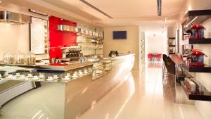 a bar in a restaurant with a counter with glasses at Park Plaza London Westminster Bridge in London