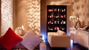 a living room with a couch and a shelf of wine bottles at Park Plaza London Westminster Bridge in London