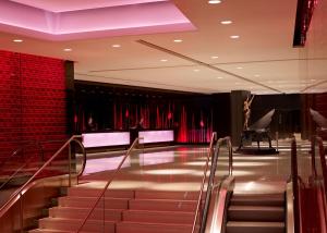 a lobby with stairs and a red wall at Park Plaza London Westminster Bridge in London