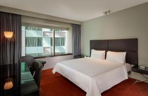 a bedroom with a large white bed and a window at Park Plaza London Westminster Bridge in London
