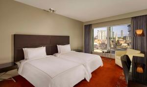 a hotel room with two beds and a large window at Park Plaza London Westminster Bridge in London