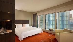 a bedroom with a large white bed and a couch at Park Plaza London Westminster Bridge in London