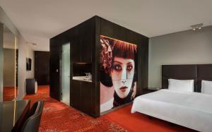a bedroom with a bed and a large painting of a woman at Park Plaza London Westminster Bridge in London