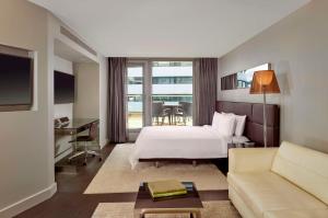 a hotel room with a bed and a couch at Park Plaza London Westminster Bridge in London