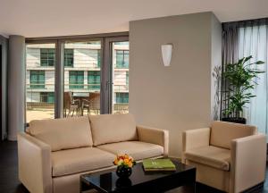 a living room with a couch and a table at Park Plaza London Westminster Bridge in London