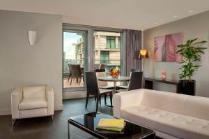 a living room with a white couch and a table at Park Plaza London Westminster Bridge in London