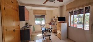 a kitchen with a table and chairs in a room at Apartamentos Real 81 in Estepona