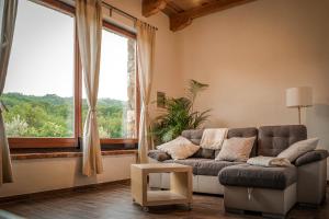 a living room with a couch and a large window at Holiday Home GaMaJaMa in Dobravlje