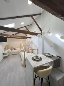 a room with a table and a bed in the background at Suites Chic Star in Herencia