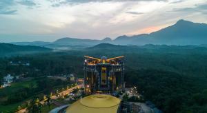 an aerial view of a building with mountains in the background at Fezinn Hotel - Best Wayanad Hotel in 2024 in Kozhikode
