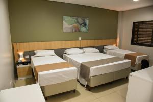 Postel nebo postele na pokoji v ubytování Hotel Plaza Garden