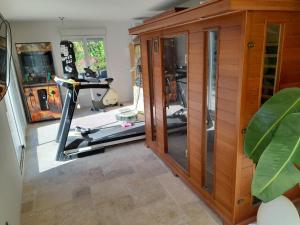 a room with a gym with a treadmill at cabane in Aspremont