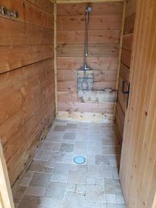 a bathroom with a shower in a wooden cabin at cabane in Aspremont