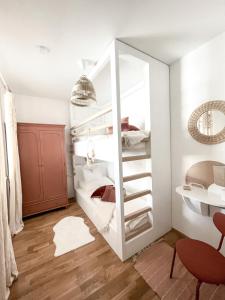 a room with two bunk beds with a mirror at Bergzeit by Alpenidyll Apartments in Aich