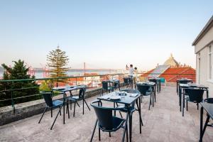 a row of tables and chairs on a balcony at Cheese & Wine Lapa in Lisbon +85 photos