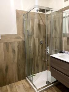 a shower with a glass door in a bathroom at Casa Woow in Carini