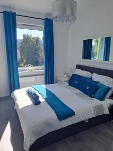 Postel nebo postele na pokoji v ubytování Apartament Słoneczny