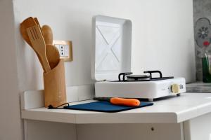 a kitchen counter with a toaster and a carrot on it at AA Central Station Historical center in Palermo +8 photos