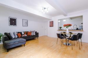 a living room with a couch and a table and chairs at Manchester City Centre 2 bed apartment in Manchester