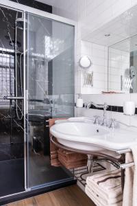 a white bathroom with a sink and a shower at De Jonge Barones in Beetsterzwaag