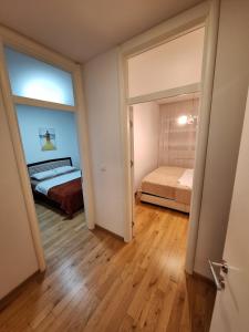 a room with a bed and a bedroom with a window at Elegantna oaza apartment in Banja Luka