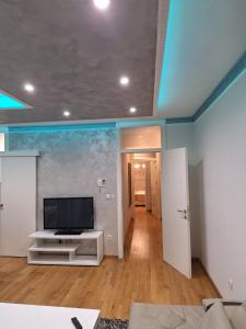 a living room with a flat screen tv on a wall at Elegantna oaza apartment in Banja Luka