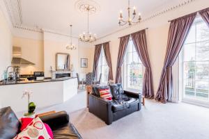 a living room with a couch and a table at Croft House - By Luxury Apartments in Cheltenham