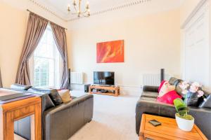 a living room with a couch and a table at Croft House - By Luxury Apartments in Cheltenham