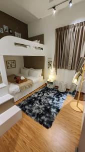 a bedroom with a bunk bed and a rug at SkyPool 2BR 9pax Premium Suite@Beacon @Georgetown @Penang in George Town