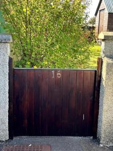 a wooden gate with the number on it at 16 Station Square in Saint Marys