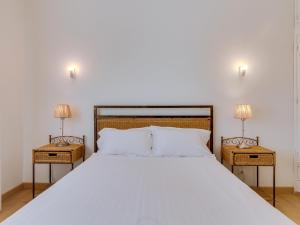 a bedroom with a large bed with two night stands at AL - Sea Front View Deluxe Apartment in Quarteira