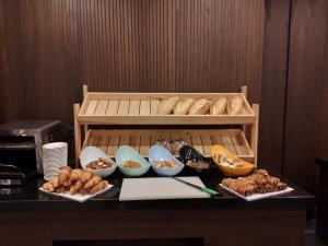 a table with different types of bread and bowls of food at Ramada by Wyndham Istanbul Umraniye in Istanbul