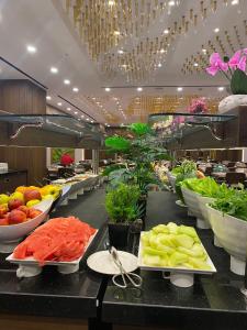 a buffet line with bowls of fruits and vegetables at Ramada by Wyndham Istanbul Umraniye in Istanbul