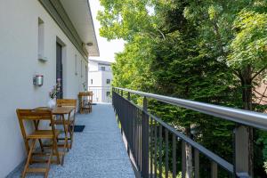 einen Balkon mit Tischen und Stühlen auf einem Haus in der Unterkunft Hotel Garni Rössli in St. Gallen