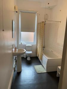 a bathroom with a sink and a toilet and a bath tub at Branxiar Castle - Stylish & Elegant 3 Bedroom Apartment in Wallsend, North Tyneside in Old Walker