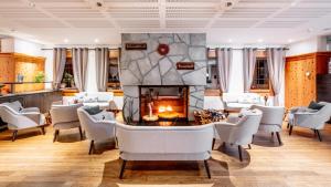a living room with a fireplace and a table and chairs at Hapimag Ferienwohnungen Flims in Flims